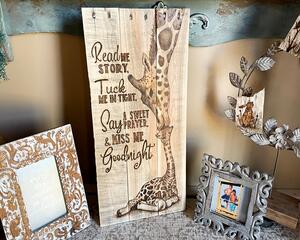 Rustic giraffe wall art for a nursery. A giraffe mother kisses a baby giraffe's head. A goodnight prayer is drawn next to them.